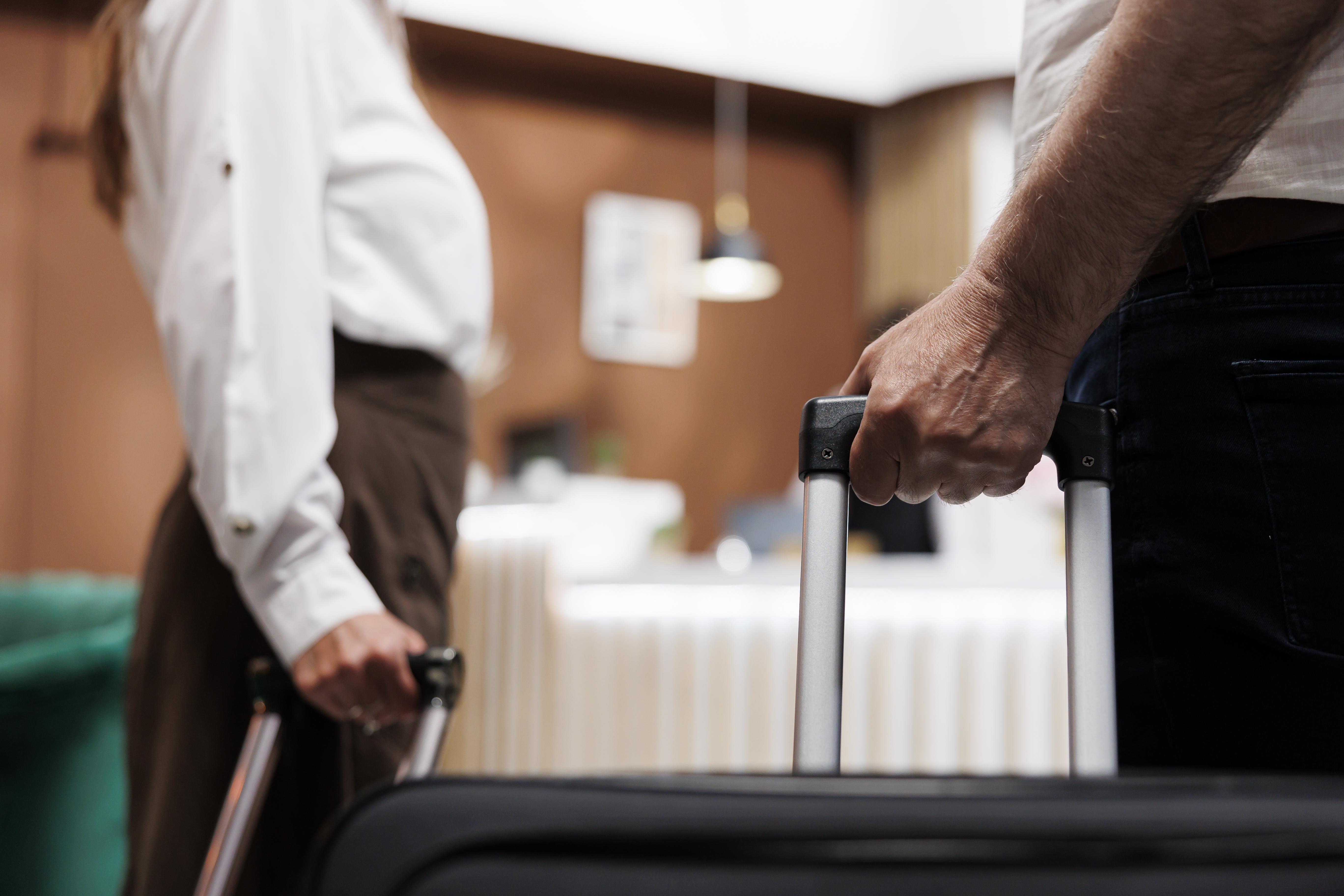 Guests with suitcases at hotel reception